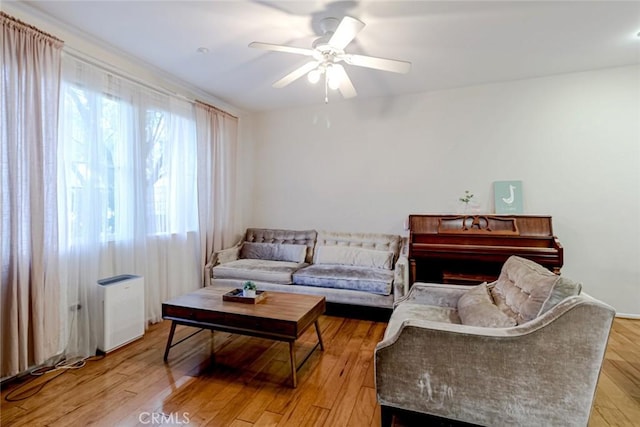 living room with ceiling fan and light wood-type flooring