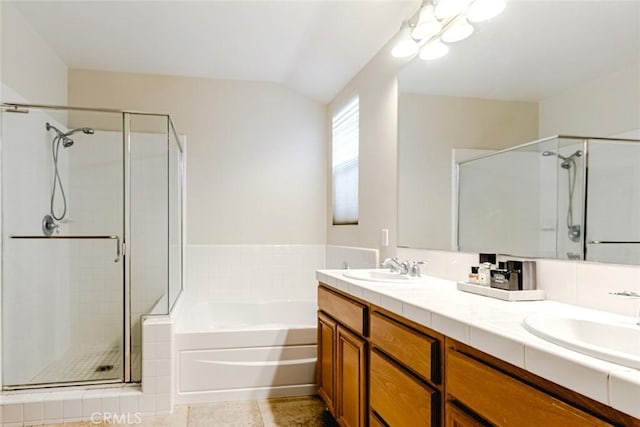 bathroom with independent shower and bath, vanity, and lofted ceiling