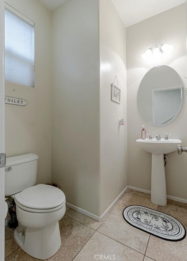 bathroom with tile patterned floors and toilet