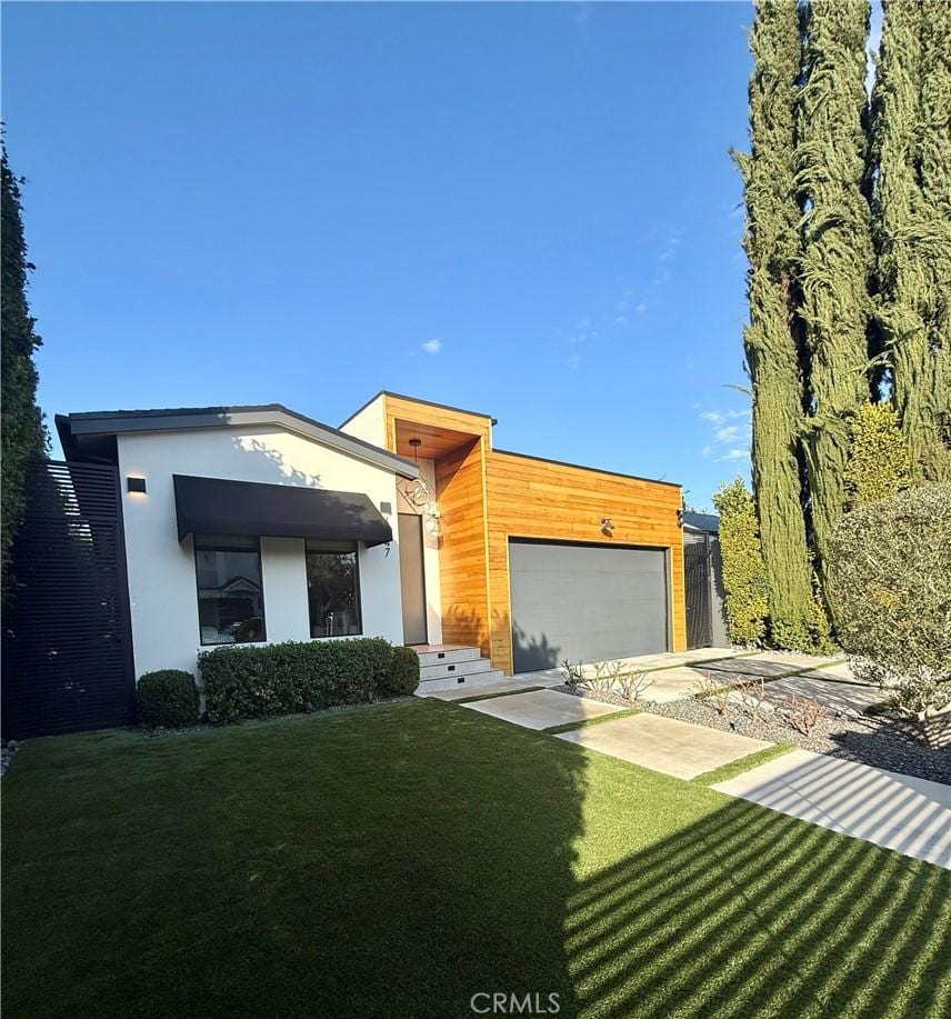 modern home with a garage and a front lawn