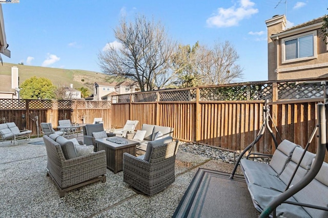 view of patio featuring an outdoor living space with a fire pit