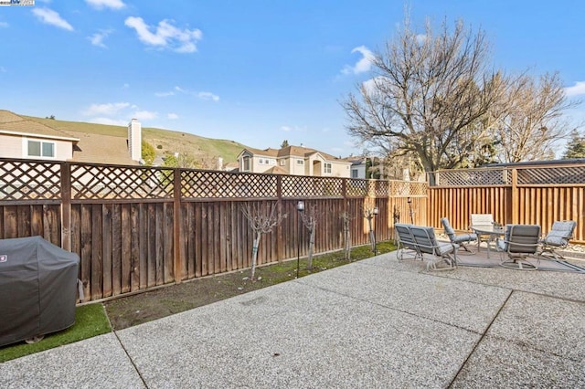 view of patio / terrace featuring a mountain view and grilling area