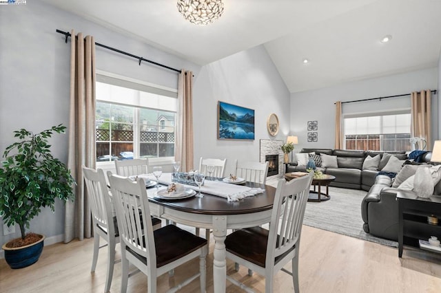 dining space with lofted ceiling and light hardwood / wood-style floors