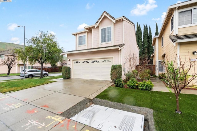 view of front of property featuring a garage and a front lawn