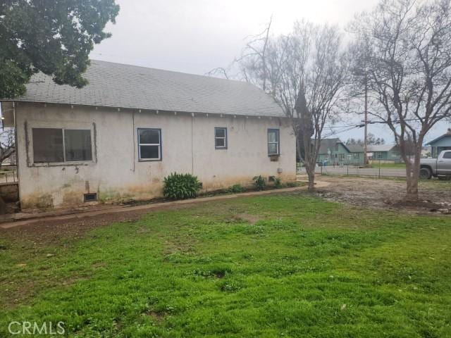 view of property exterior with a yard