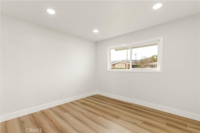 spare room featuring light hardwood / wood-style floors