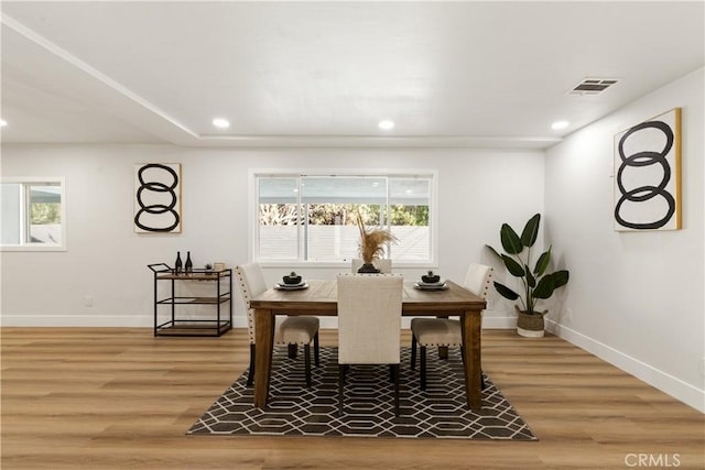 dining space with hardwood / wood-style floors