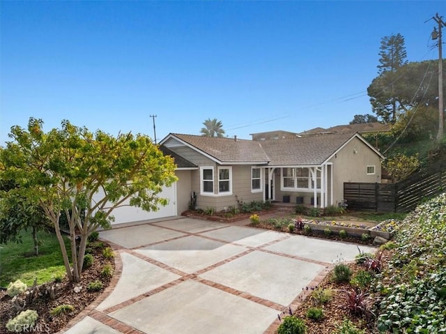 single story home featuring fence, a garage, driveway, and stucco siding