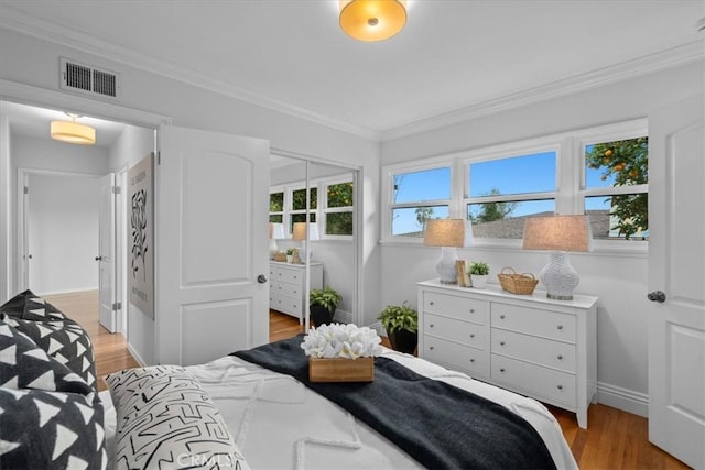 bedroom featuring light hardwood / wood-style flooring and ornamental molding