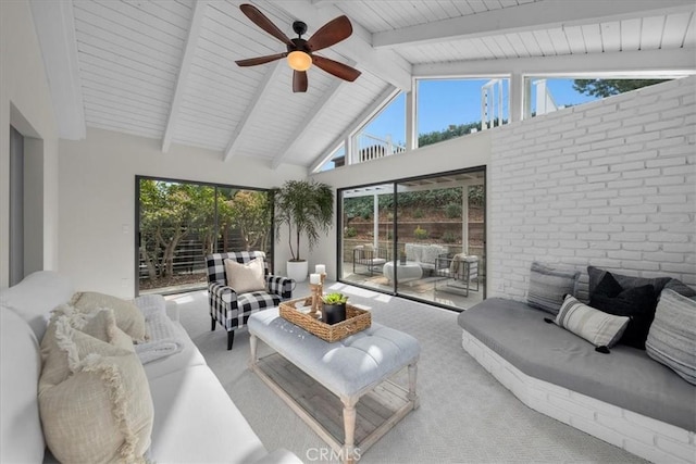 sunroom with lofted ceiling with beams and ceiling fan