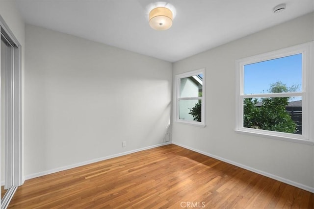 unfurnished bedroom featuring a closet and light wood-type flooring