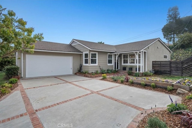 single story home with an attached garage, fence, driveway, and stucco siding