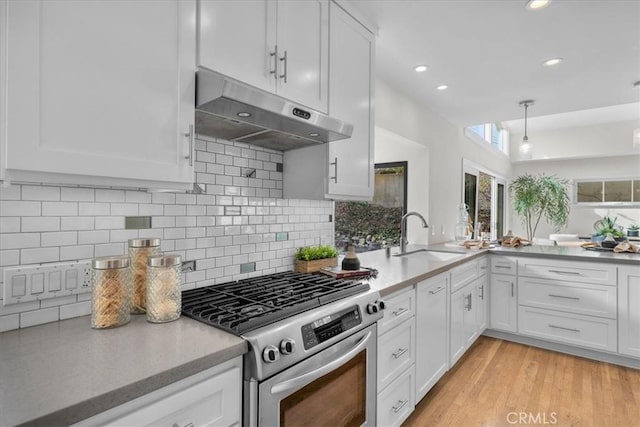 kitchen featuring white cabinetry, stainless steel gas range, sink, and light hardwood / wood-style flooring