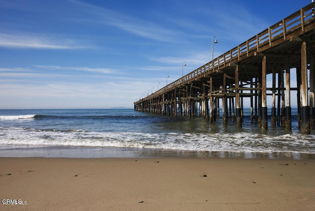 dock area with a water view and a view of the beach