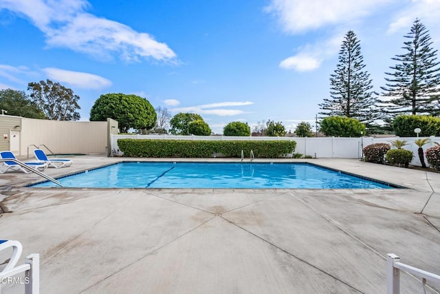 view of swimming pool with a patio area