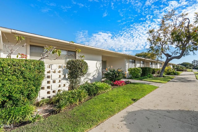 view of property exterior with a yard