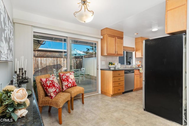 kitchen featuring light brown cabinetry, sink, tasteful backsplash, and appliances with stainless steel finishes