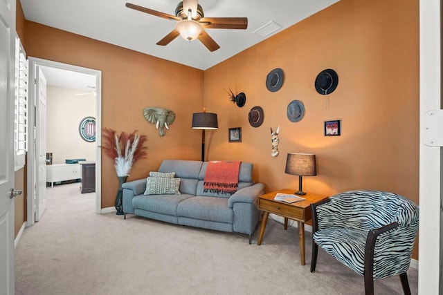 living room with light colored carpet and ceiling fan