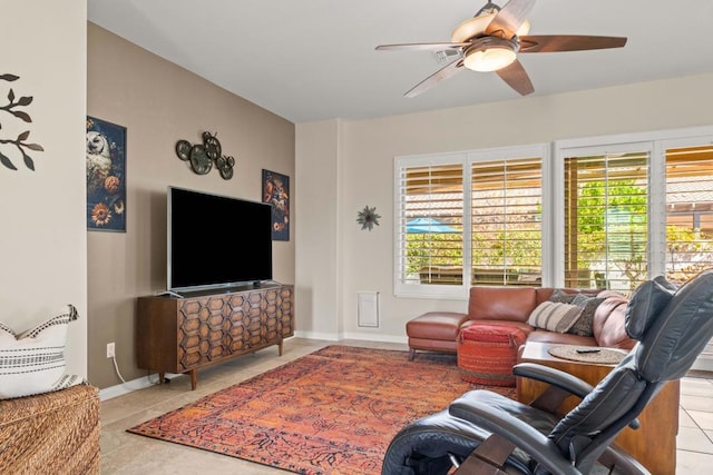 tiled living room with ceiling fan and a healthy amount of sunlight