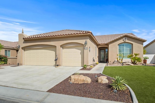 mediterranean / spanish-style home with a garage and a front yard