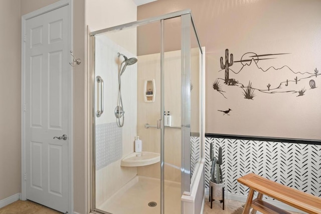 bathroom featuring a shower with door