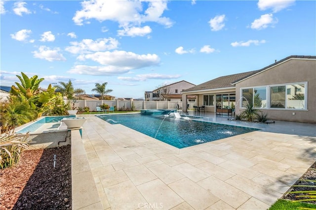 view of swimming pool featuring a patio, pool water feature, and a jacuzzi