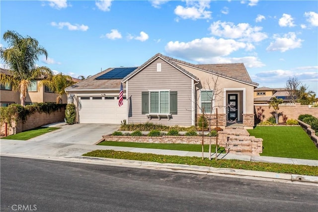 ranch-style home with a garage, a front yard, and solar panels