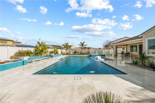 view of swimming pool featuring pool water feature and a patio