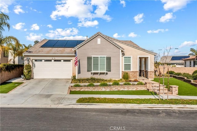 ranch-style house with a garage and solar panels