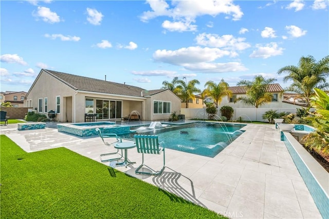 view of swimming pool featuring an in ground hot tub, pool water feature, a yard, and a patio