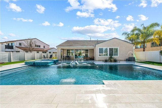 view of pool with a patio, pool water feature, and an in ground hot tub