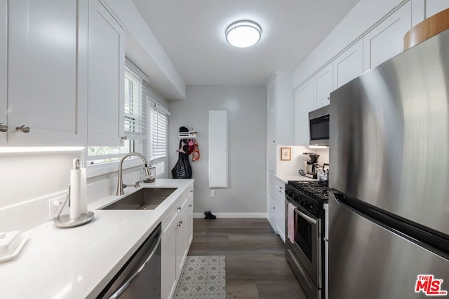 kitchen with white cabinetry, sink, dark wood-type flooring, and stainless steel appliances