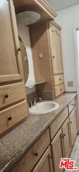 bathroom featuring vanity and tile patterned flooring