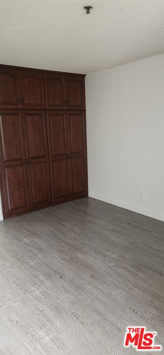 interior space with light hardwood / wood-style flooring and a textured ceiling