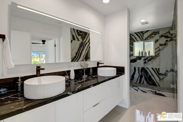 bathroom with vanity and tiled shower