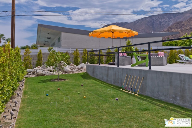 view of yard featuring a patio and a mountain view