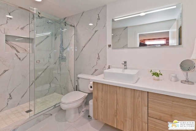 bathroom with vanity, a shower with door, and toilet