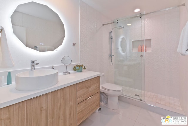 bathroom featuring tile patterned floors, vanity, toilet, and an enclosed shower