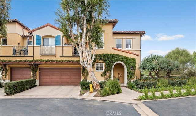 mediterranean / spanish-style home featuring a garage