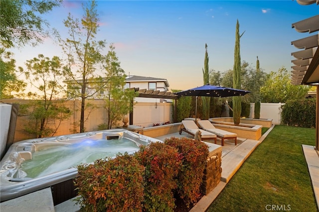 yard at dusk with a hot tub