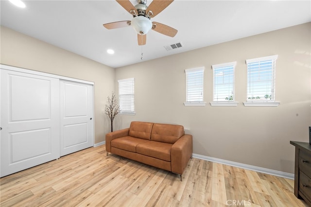 living area featuring ceiling fan and light hardwood / wood-style flooring