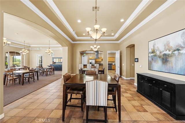 carpeted dining space featuring an inviting chandelier, crown molding, and a raised ceiling