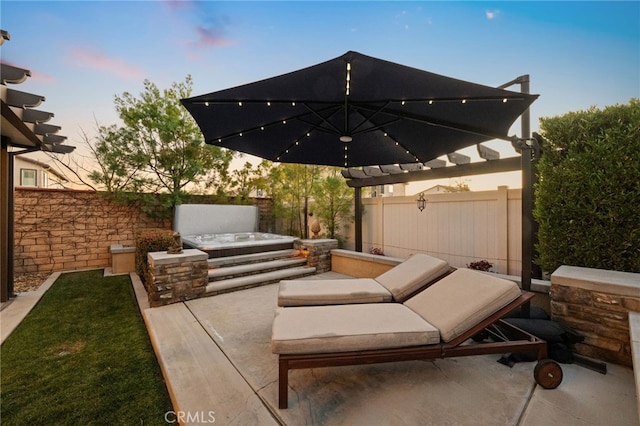 patio terrace at dusk with a hot tub