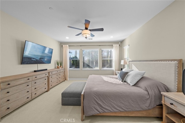 bedroom featuring ceiling fan and light colored carpet