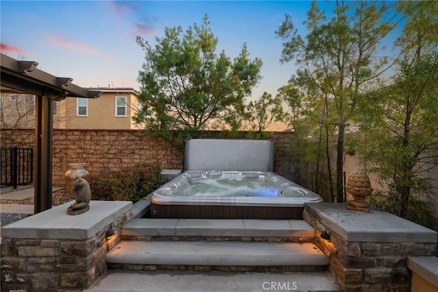 patio terrace at dusk with a covered hot tub