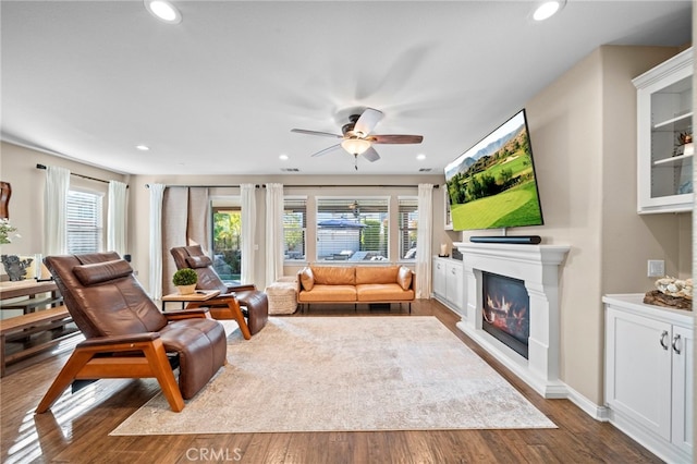 living room with wood-type flooring, a healthy amount of sunlight, and ceiling fan