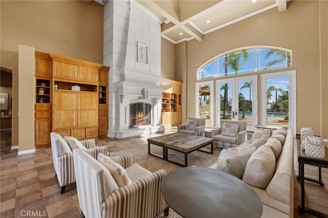 living room featuring french doors, coffered ceiling, beamed ceiling, a towering ceiling, and a fireplace