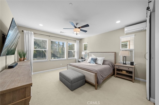 carpeted bedroom with ceiling fan and a wall mounted AC