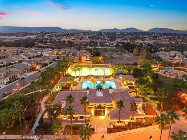 aerial view at dusk featuring a mountain view