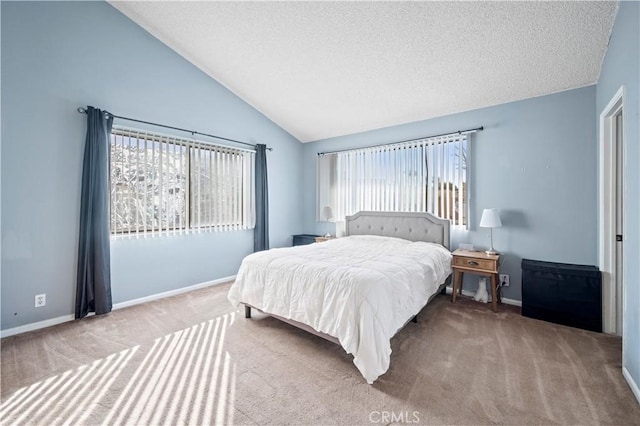 bedroom with vaulted ceiling, carpet, and a textured ceiling